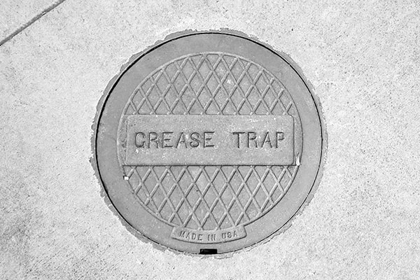regular grease trap pumping helps prevent blockages and backups in your commercial kitchen plumbing